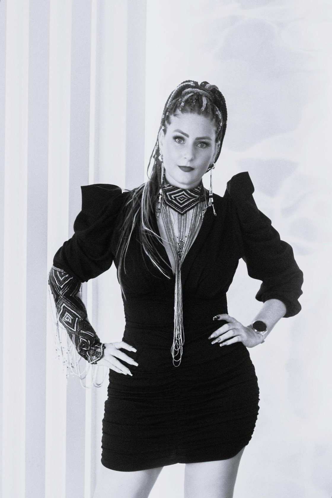 Anika Stevens, founder of FAIR BLVD, wearing a hand-beaded neckpiece