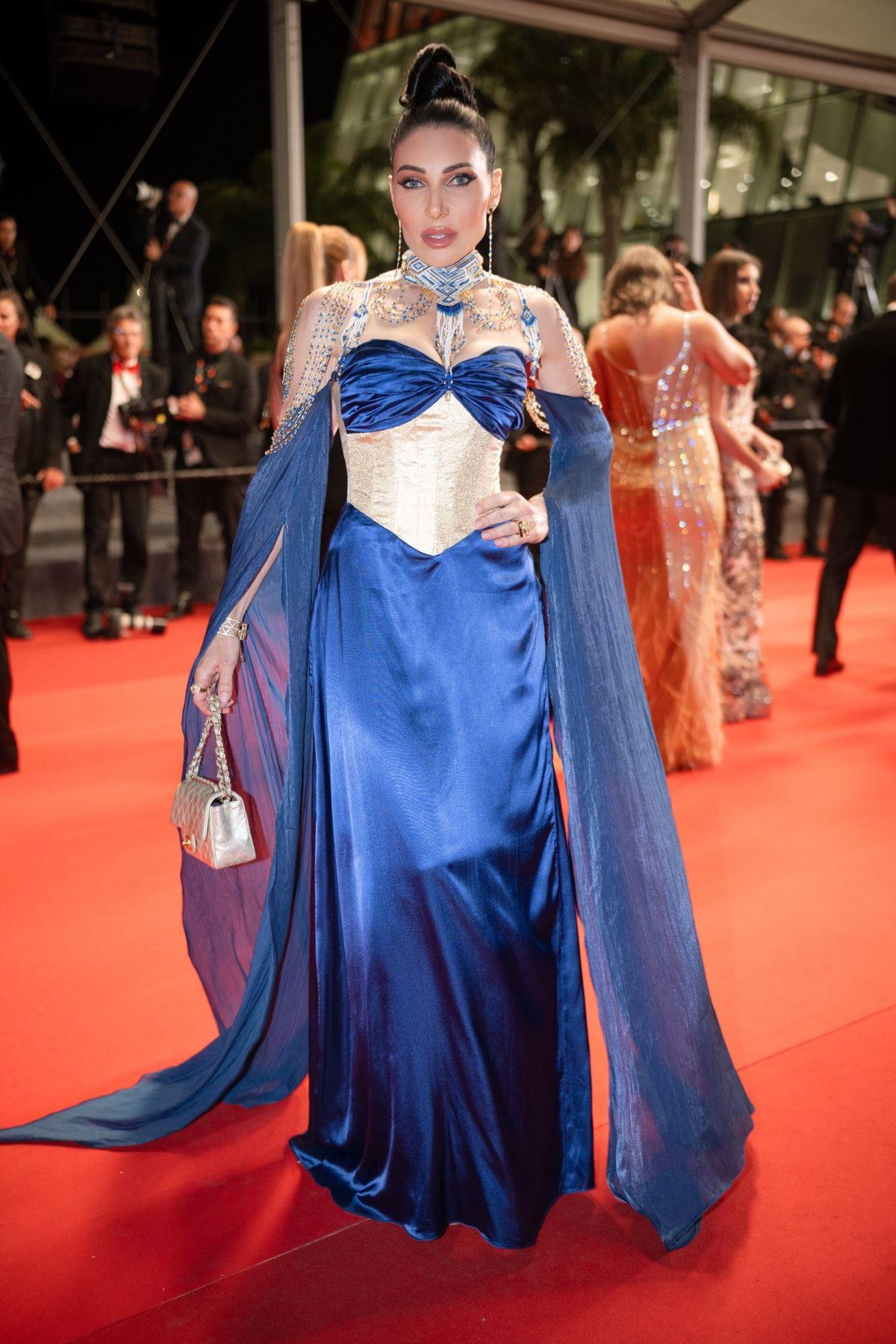 Actress Dana Vargova in a blue FAIR BLVD gown on the Cannes Film Festival red carpet, a look later featured by Harper's Bazaar